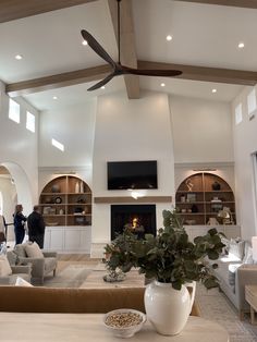 a living room filled with furniture and a ceiling fan