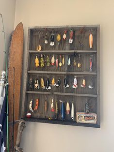 an old wooden shelf holding many different types of fishing lures