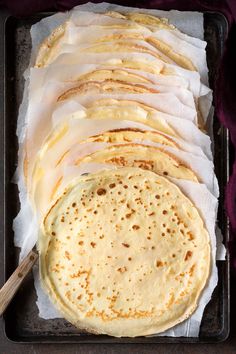 several flat breads are lined up on a baking sheet