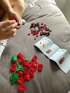 a child is playing with legos on the bed