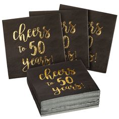 three black napkins with gold foil lettering and cheers to 40 years written on them