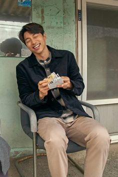 a man sitting in a chair and smiling