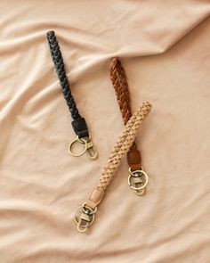 two braided leashes laying on top of a bed next to eachother