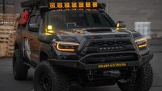 a black truck with yellow lights on it