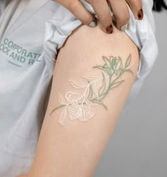 a woman's arm with a flower tattoo on the left side of her body