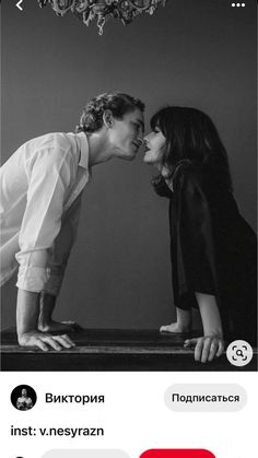 two people kissing each other in front of a chandelier with the words love on it