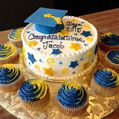 a graduation cake and cupcakes on a plate