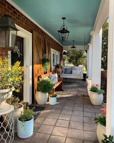 a porch with potted plants on it