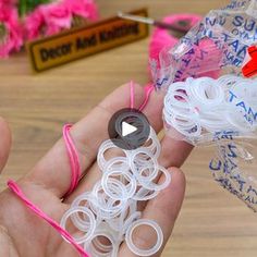 a person holding several different types of rubber bands in their hand, with the video showing them