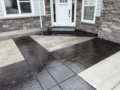 a house with black and white tiles on the ground