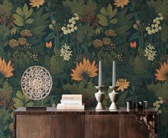 a sideboard with two vases on it next to a wallpapered background