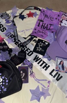 purple and white items spread out on top of a bed with the words, you're that girl written on them