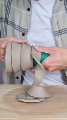 a person is using an object to make it look like a cone with a green handle