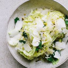 a white bowl filled with food on top of a table