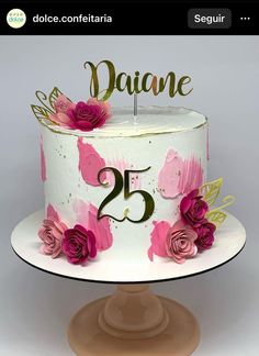 a white cake with pink flowers and the number twenty five