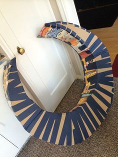 a blue and white wreath sitting on top of a floor next to an open door