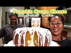 two people standing next to a pumpkin cream cheese bundt cake