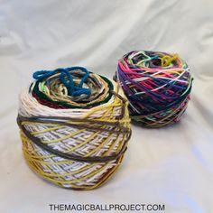 two balls of yarn sitting next to each other on a white surface with text overlay that says, the magic ball project