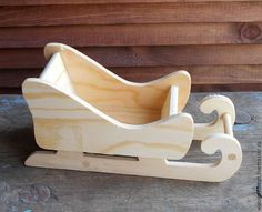 a wooden toy sleigh sitting on top of a table