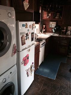 a white refrigerator freezer sitting inside of a kitchen next to a washer and dryer