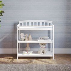 a white shelf with stuffed animals on it