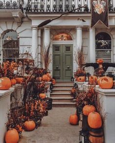 a house with pumpkins on the front steps