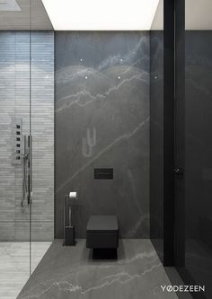 a modern bathroom with black and white marbled walls, an open shower stall and a glass sliding door