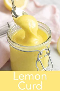 lemon curd in a glass jar with a spoon sticking out of it and the text overlay reads, lemon curd