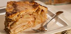 a slice of apple pie on a plate with a fork