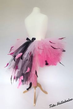 a mannequin with pink and black feathers on it