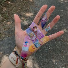 a person's hand is covered with different images of princesses on their fingers