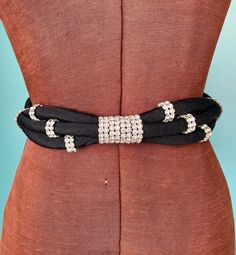 Deadstock, 80s Saks Fifth Avenue, black ribbon rope belt with rhinestone wrapped centerpiece and tie back closure Condition: EXCELLENT, deadstock. Brand: Saks Fifth Avenue TOTAL LENGTH: 45.5" BEST FITS: 25" TO 33" Waist WIDTH: 1.25"  P.S: I love hearing from you...Please feel free to message me with questions! Instagram It: @taralynevansstudio Website: www.TaraLynEvansStudio.com Please read over all of our store policies before making your purchase: https://www.etsy.com/shop/TaraLynEvansStudio?r 80s Belt, Festival Poncho, Black Waist Belt, Vintage Cape, Rope Belt, Belt Vintage, Black Rope, Rhinestone Belt, Designer Belt