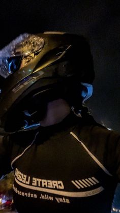 a person wearing a black shirt and helmet