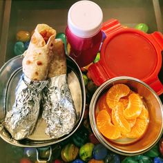 some food that is sitting on top of tin foil and in bowls next to each other