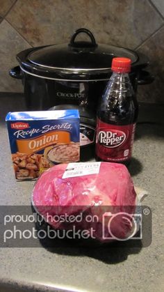 ingredients for slow cooker pork roast sitting on the kitchen counter next to an open crock pot