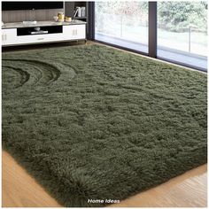 a large green rug in the middle of a room