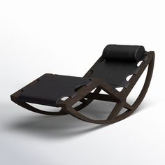 a black chair sitting on top of a white floor next to a wooden rocking chair