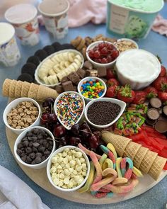 a platter filled with different types of ice cream and toppings on top of it