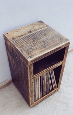 an old wooden record box with vinyl records in it's storage compartment on the floor