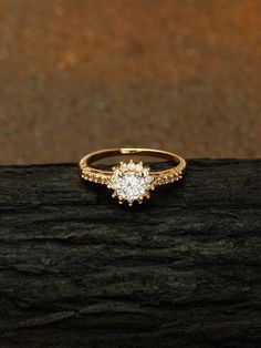 an engagement ring on top of a piece of wood