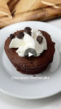 a white plate topped with a chocolate cake covered in whipped cream