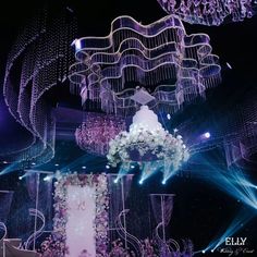 an elaborately decorated stage with chandeliers and flowers