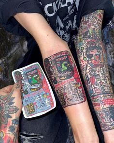 two people with matching tattoos on their arms