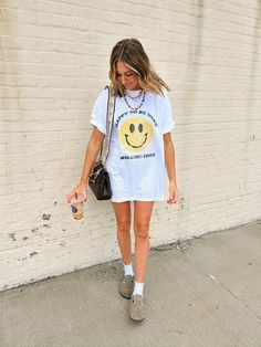 nothing but good times & smileys around here! kendra would get large for a more tts fit and would get xl for baggy vibes!! kendra tts is m/l and is 6-8 in bottoms, she is 5'9", 34B white comfort colors tee unisex loose fit 100% cotton * we always recommend sizing up in any sort of graphic because we both love an oversized baggy fit. for a more tts get your usual size. Etta Originals can take up to 4-6 business days to ship Long Graphic Tee Outfits, Cute Graphic Print T-shirt For Day Out, Sporty Graphic Print Tops For The Weekend, Trendy Funny Print T-shirt For Day Out, Trendy T-shirt With Funny Print For Day Out, Sporty Graphic Print T-shirt For Day Out, Trendy Smiley Face T-shirt For Summer, Trendy Short Sleeve T-shirt For Weekend, Graphic Print T-shirt For Spring Weekend