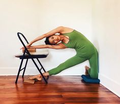 a woman is doing yoga on a chair