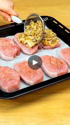 someone grating raw meat on a baking sheet