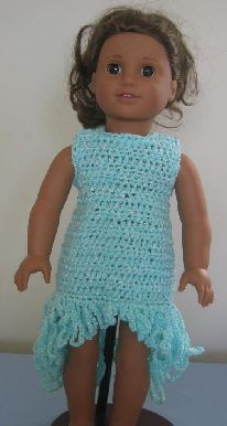 the doll is wearing a crocheted blue dress