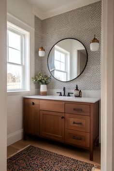 a bathroom with a sink, mirror and rug