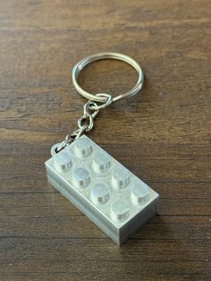 a lego keychain sitting on top of a wooden table