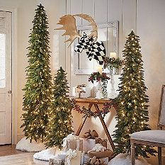 christmas trees and presents in front of a fireplace